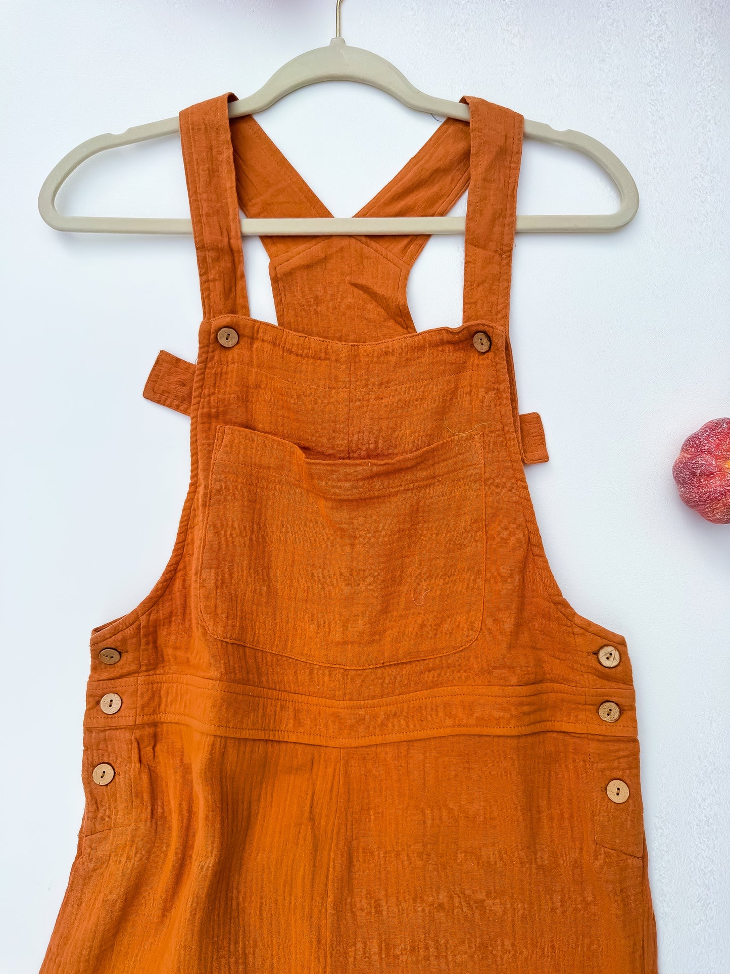 Rust gauze overalls bib pocket and strap detail