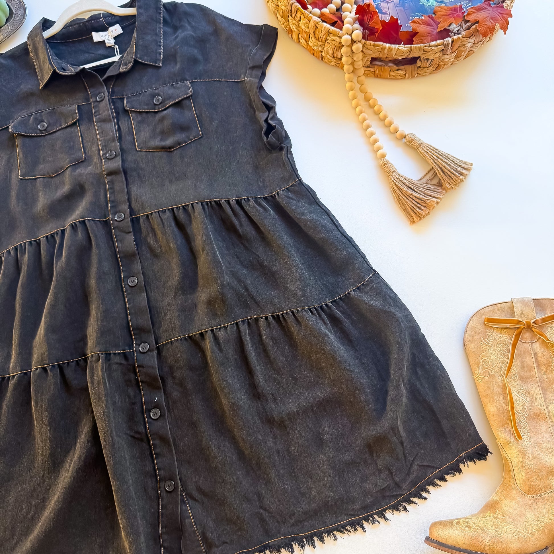Angled view of tiered skirt on washed black Umgee plus shirt dress