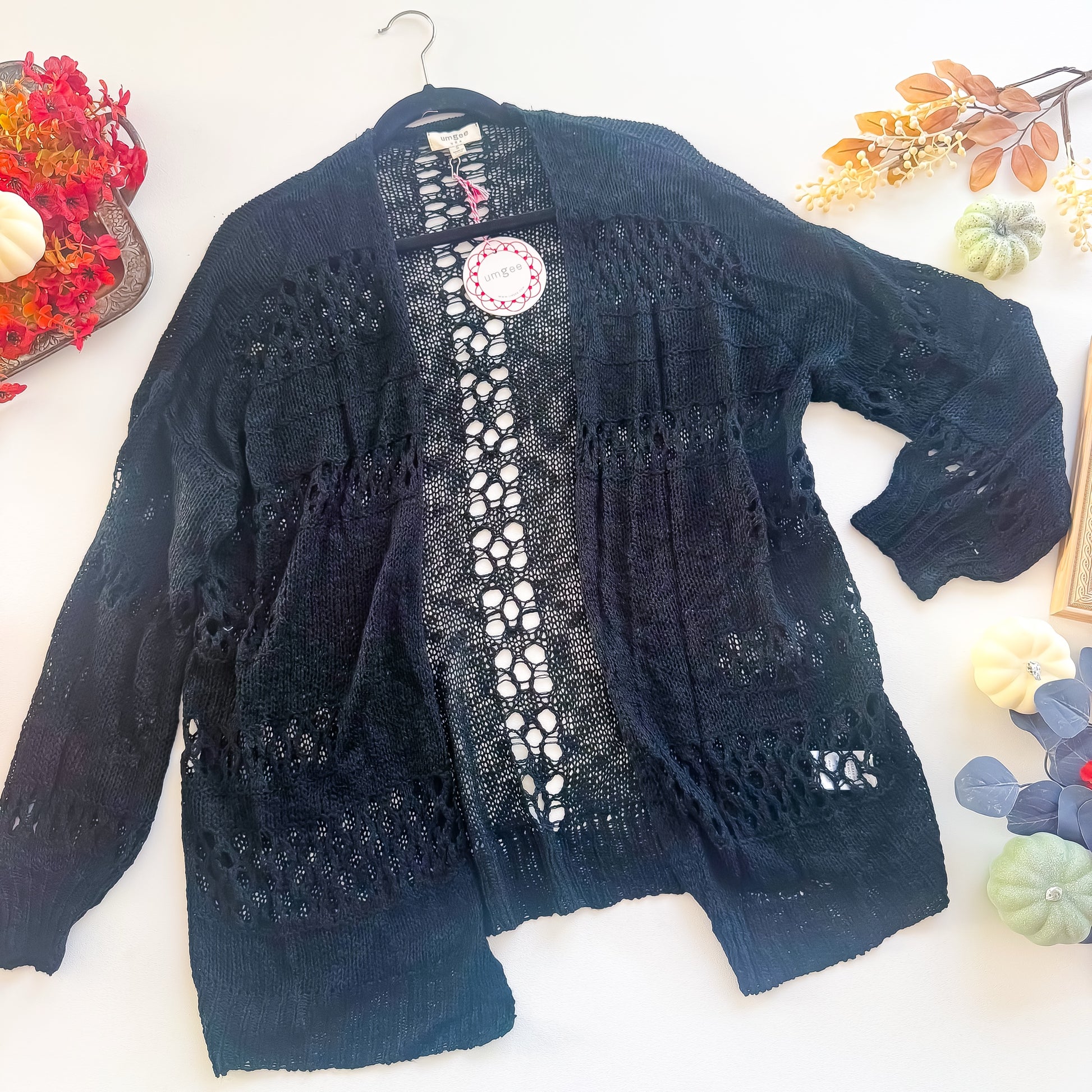 Black open knit pointelle cardigan flat lay