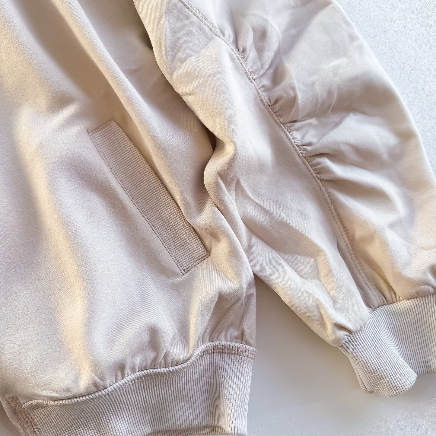 Cream bomber jacket pocket and ruched sleeve detail