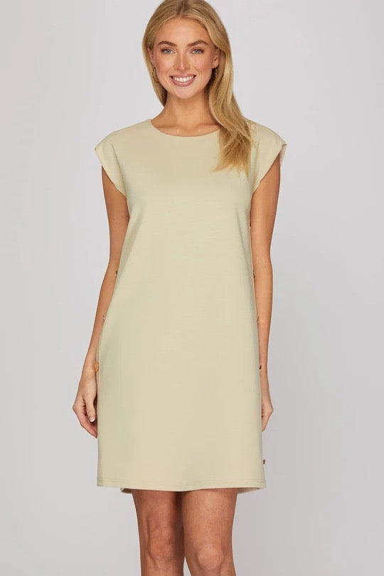 Ecru sleeveless side button knit mini dress on model