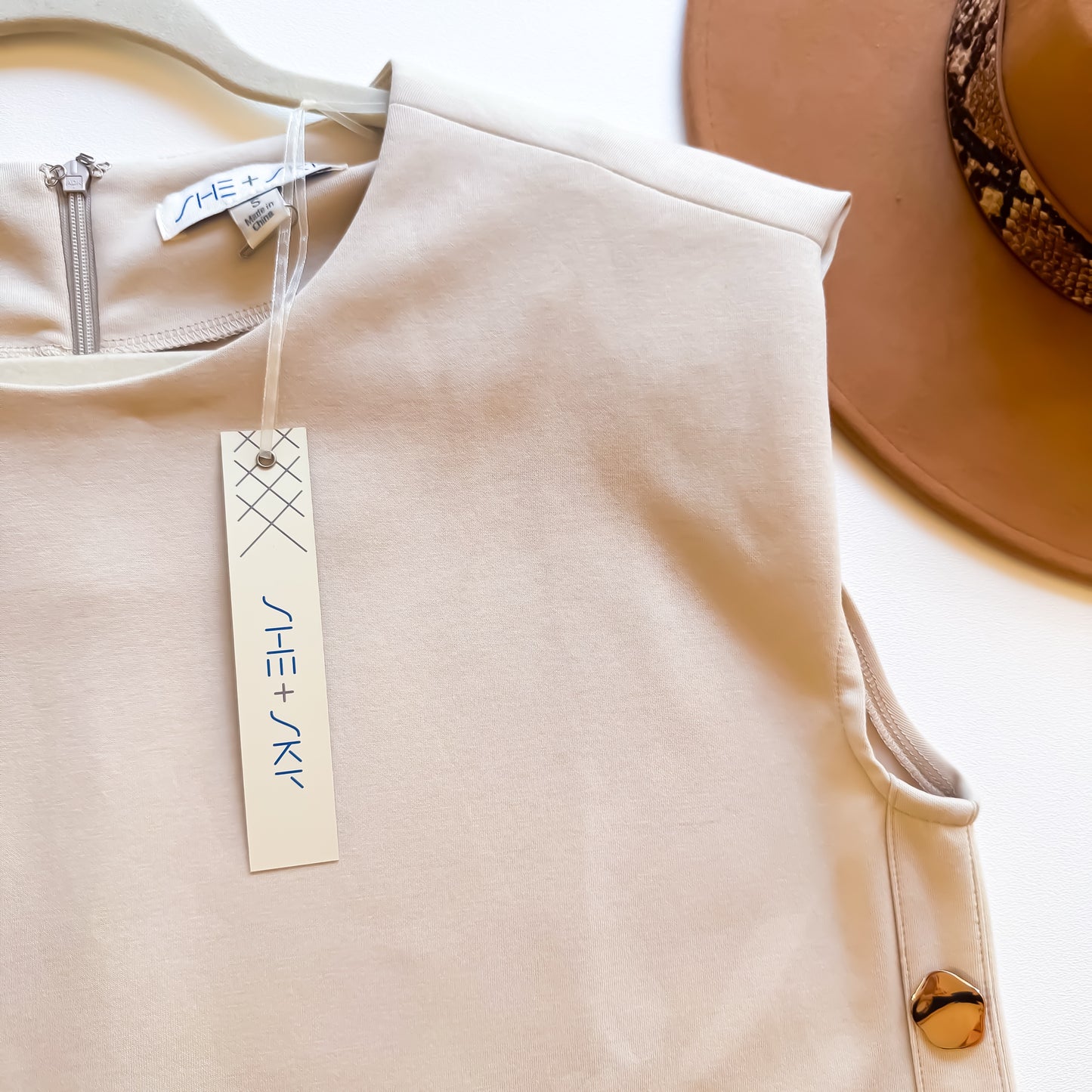 Ecru dress neckline and button detail