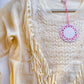 Cream fringe sweater neckline detail