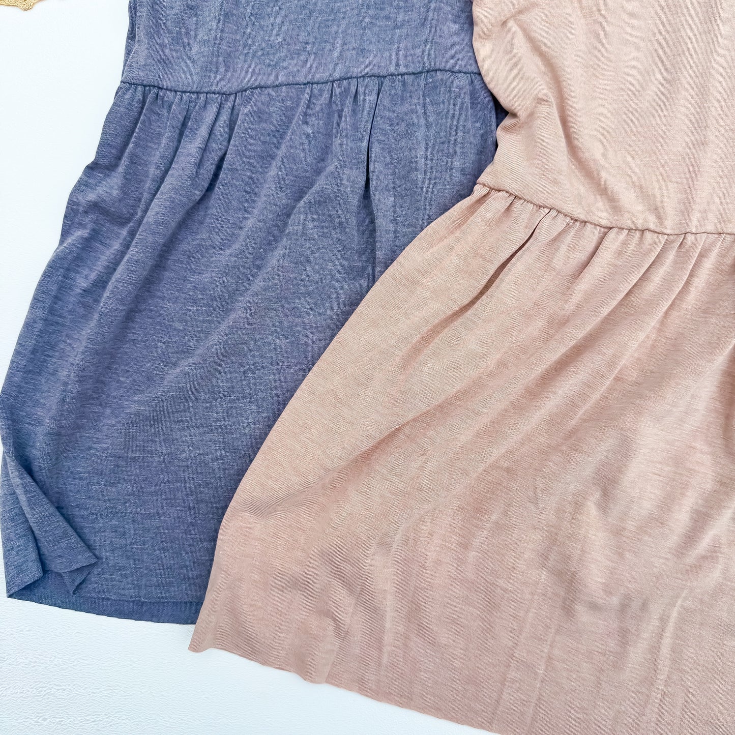 Peplum hem detail in slate blue and dusty rose