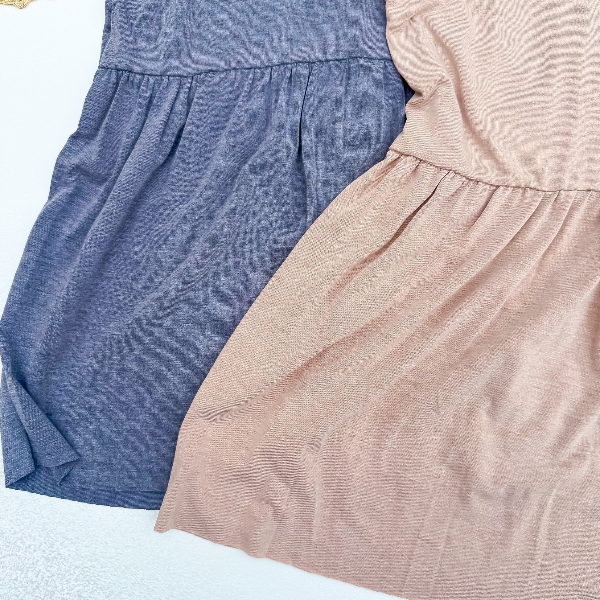 Peplum hem detail in slate blue and dusty rose