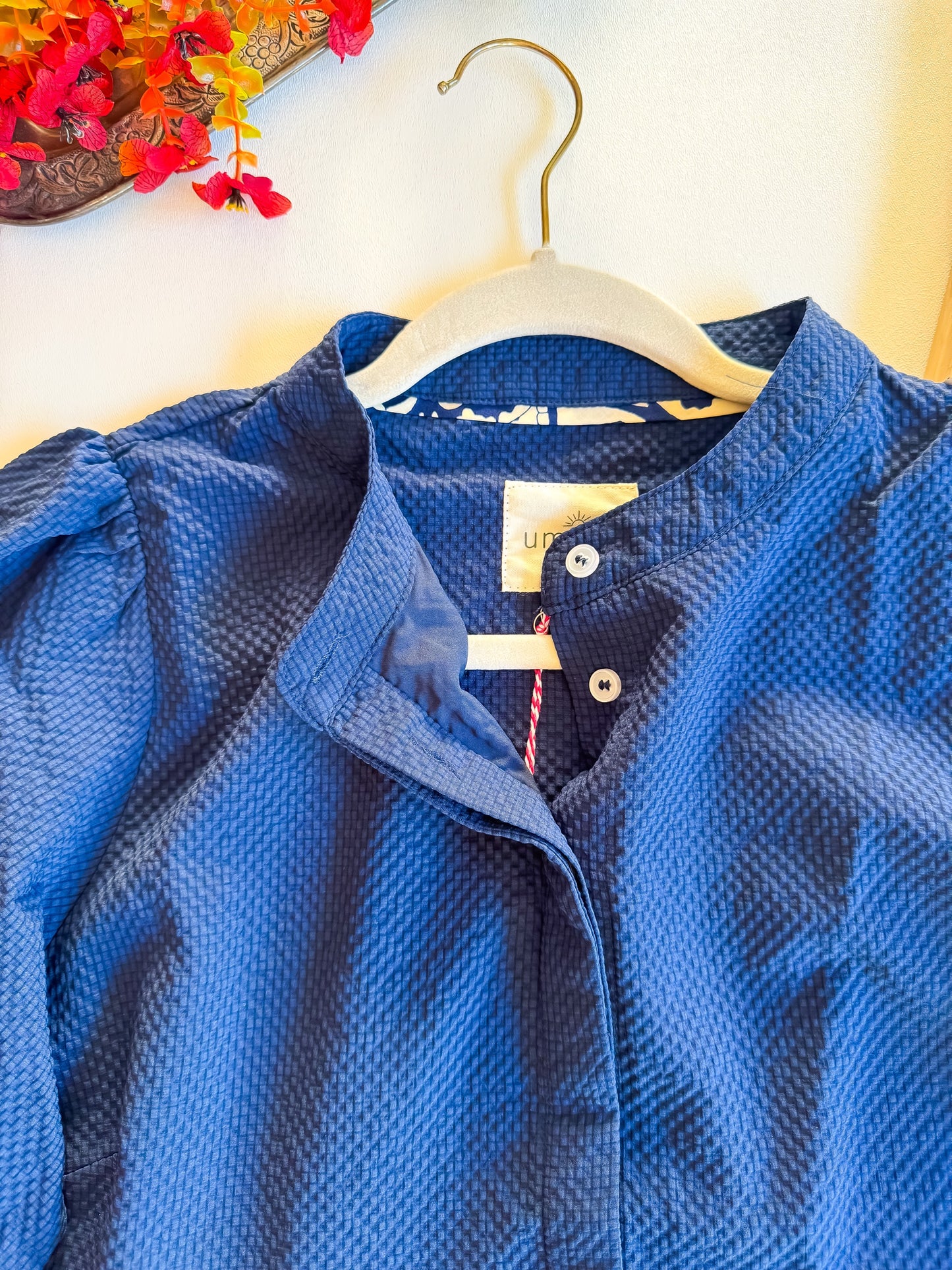 Close-up of mandarin collar and button placket on navy Umgee dress