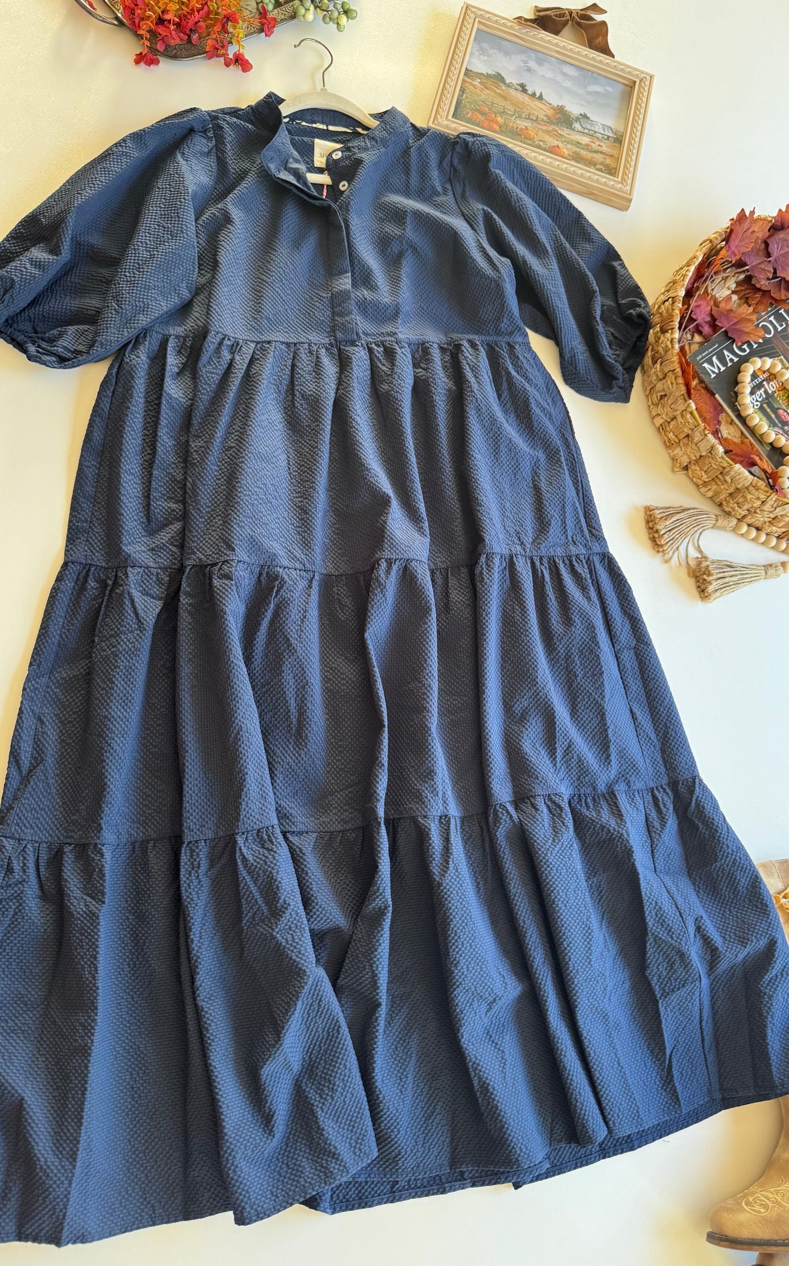 Navy tiered Umgee dress with puff sleeves and seersucker texture, flat lay