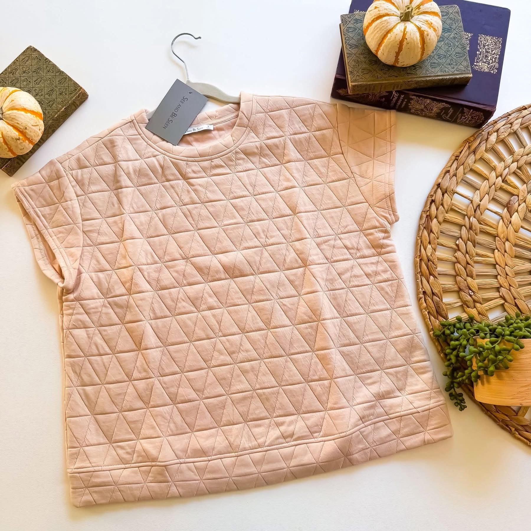 Blush quilted cap sleeve top flat lay