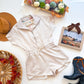 Cream half-zip drawstring romper flat lay