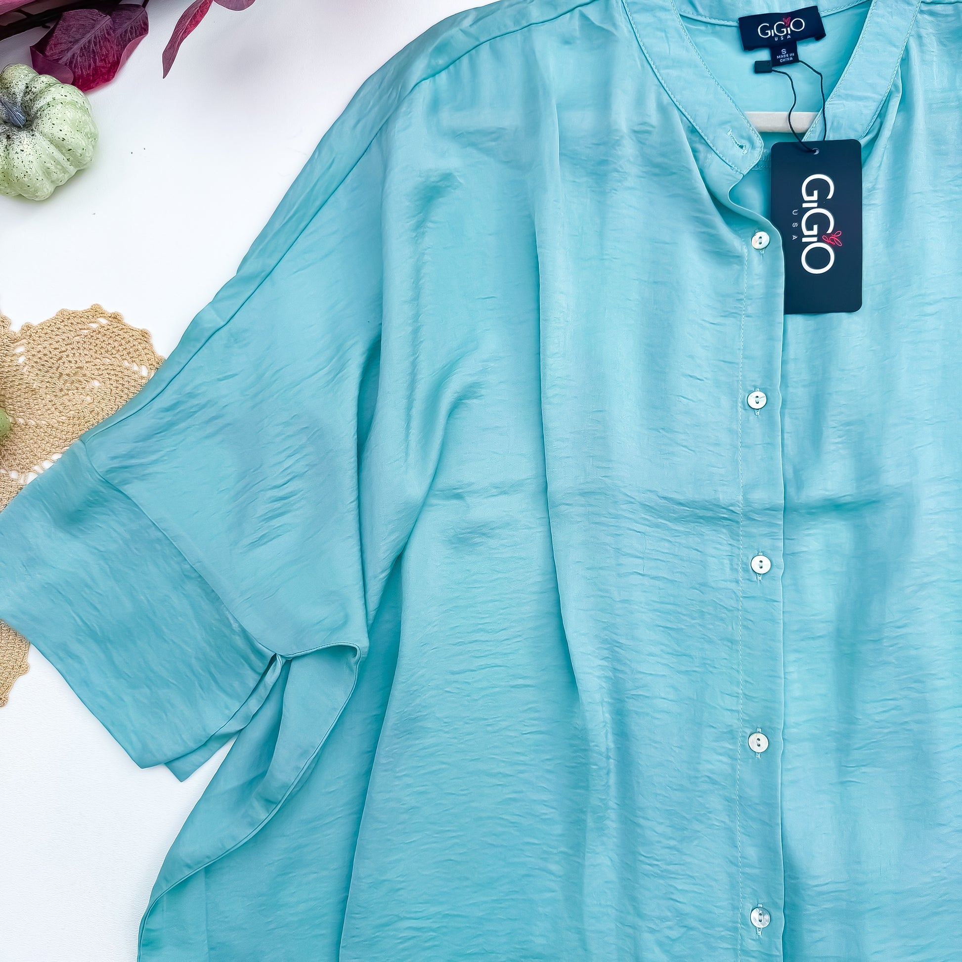 Seafoam satin blouse button and sleeve detail