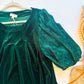 Close-up of ribbed velvet puff sleeve and pleated scoop neckline on emerald Umgee top