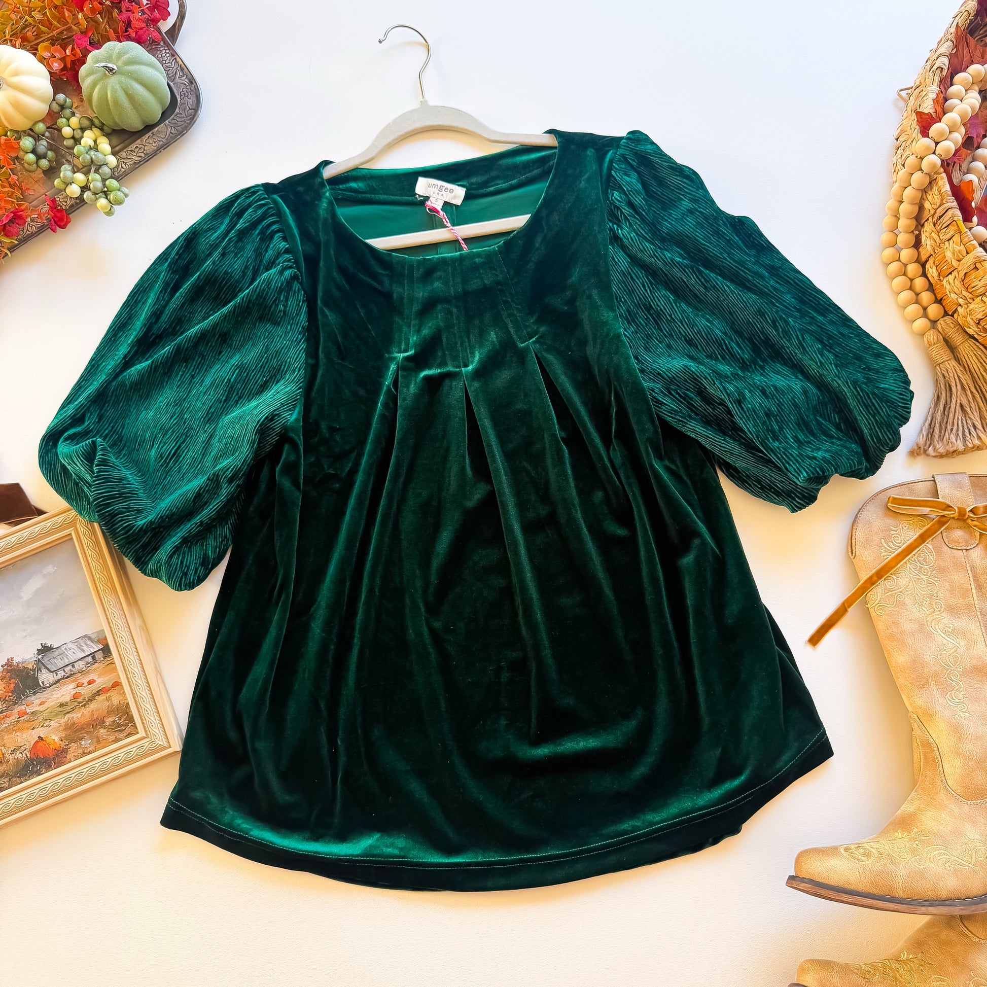 Emerald green velvet Umgee top with puff sleeves and front pleats, flat lay