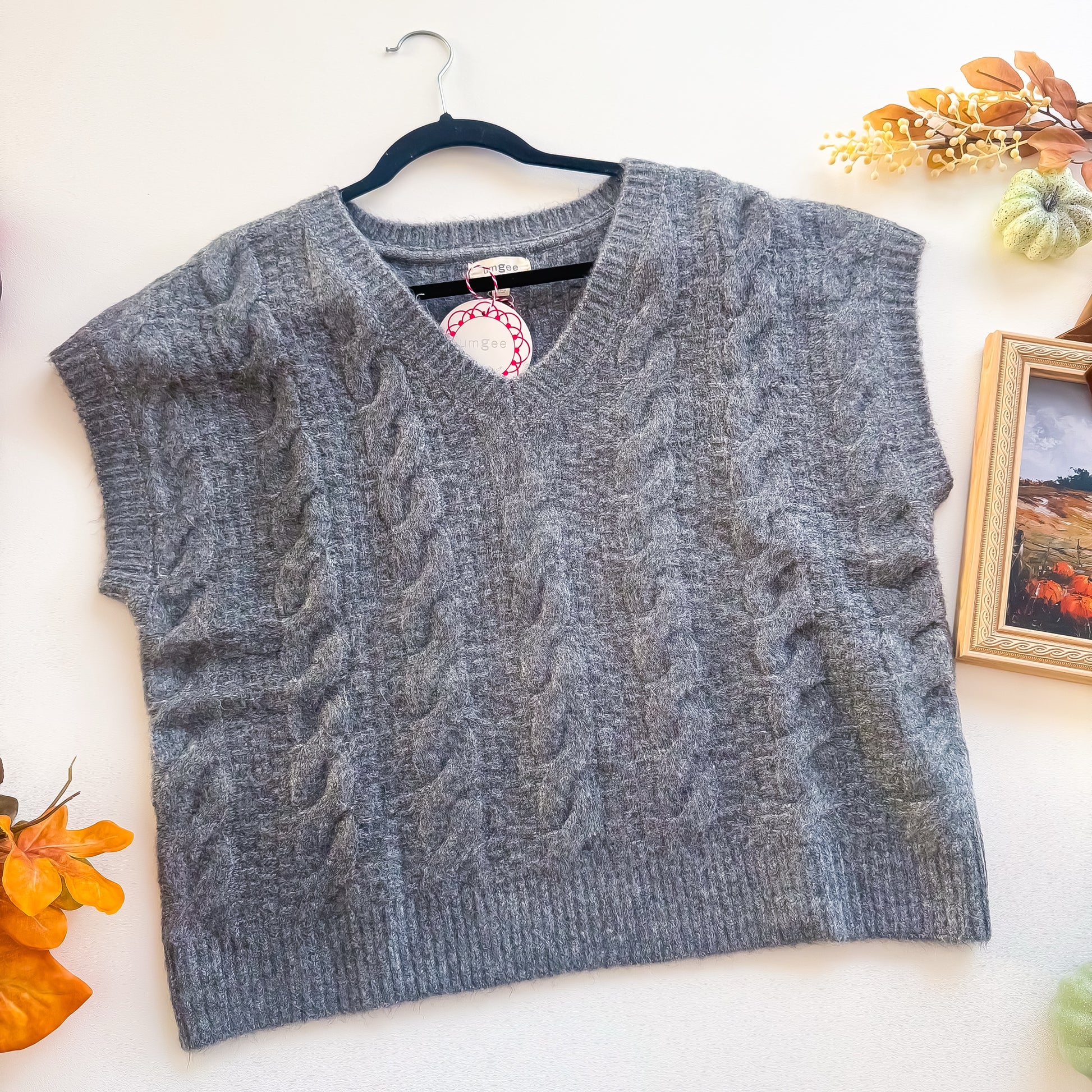 Charcoal cable knit fuzzy V-neck sweater vest close up
